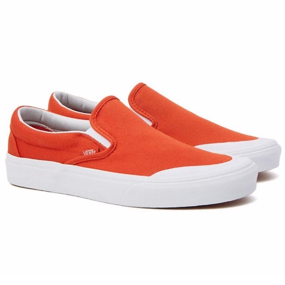 orange and white slip on vans